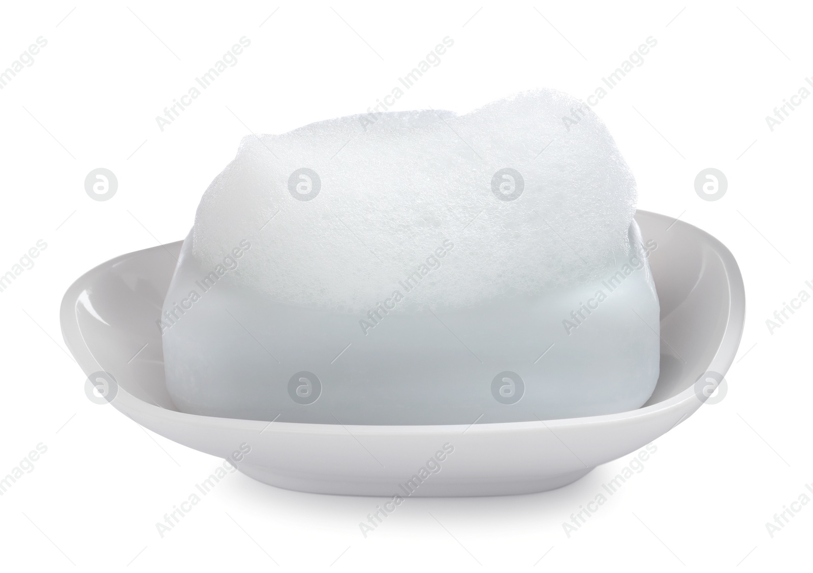 Photo of Soap bar with fluffy foam in holder on white background