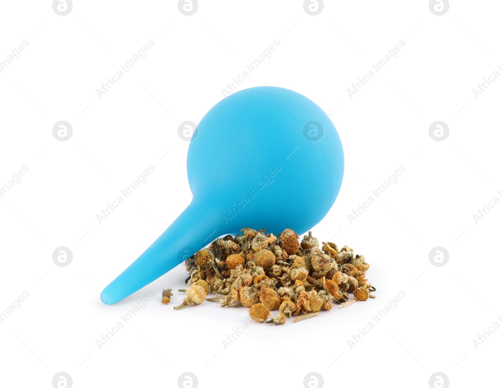 Photo of Blue enema and dry chamomile flowers on white background