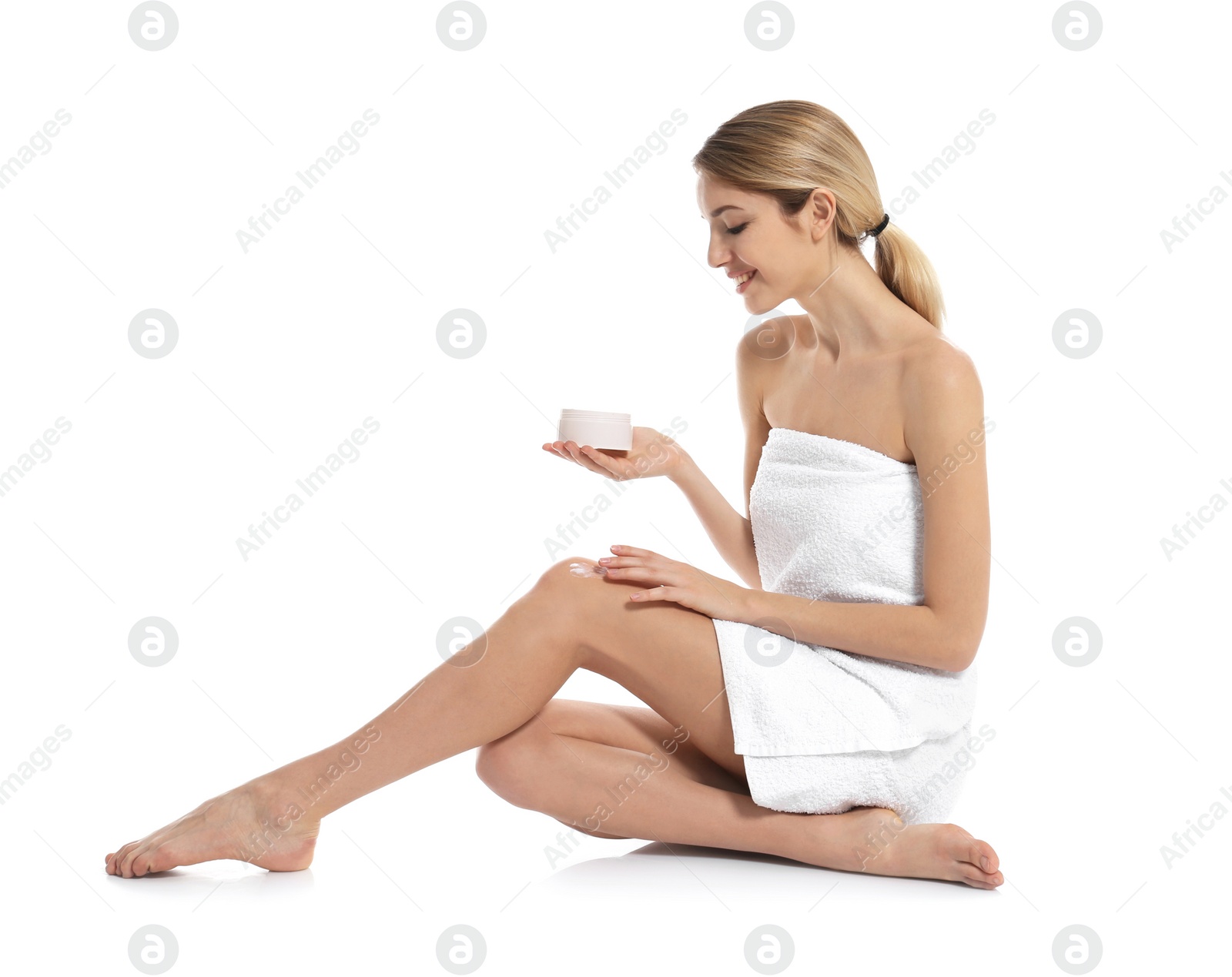 Photo of Young woman with jar of body cream on white background