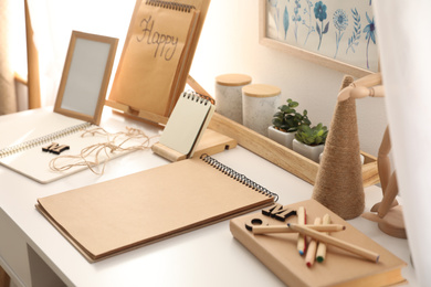 Set of stationery on white table indoors. Interior elements