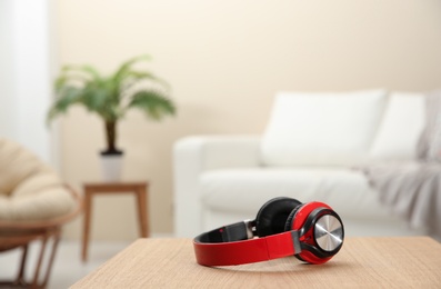 Photo of Stylish headphones on table indoors. Space for text