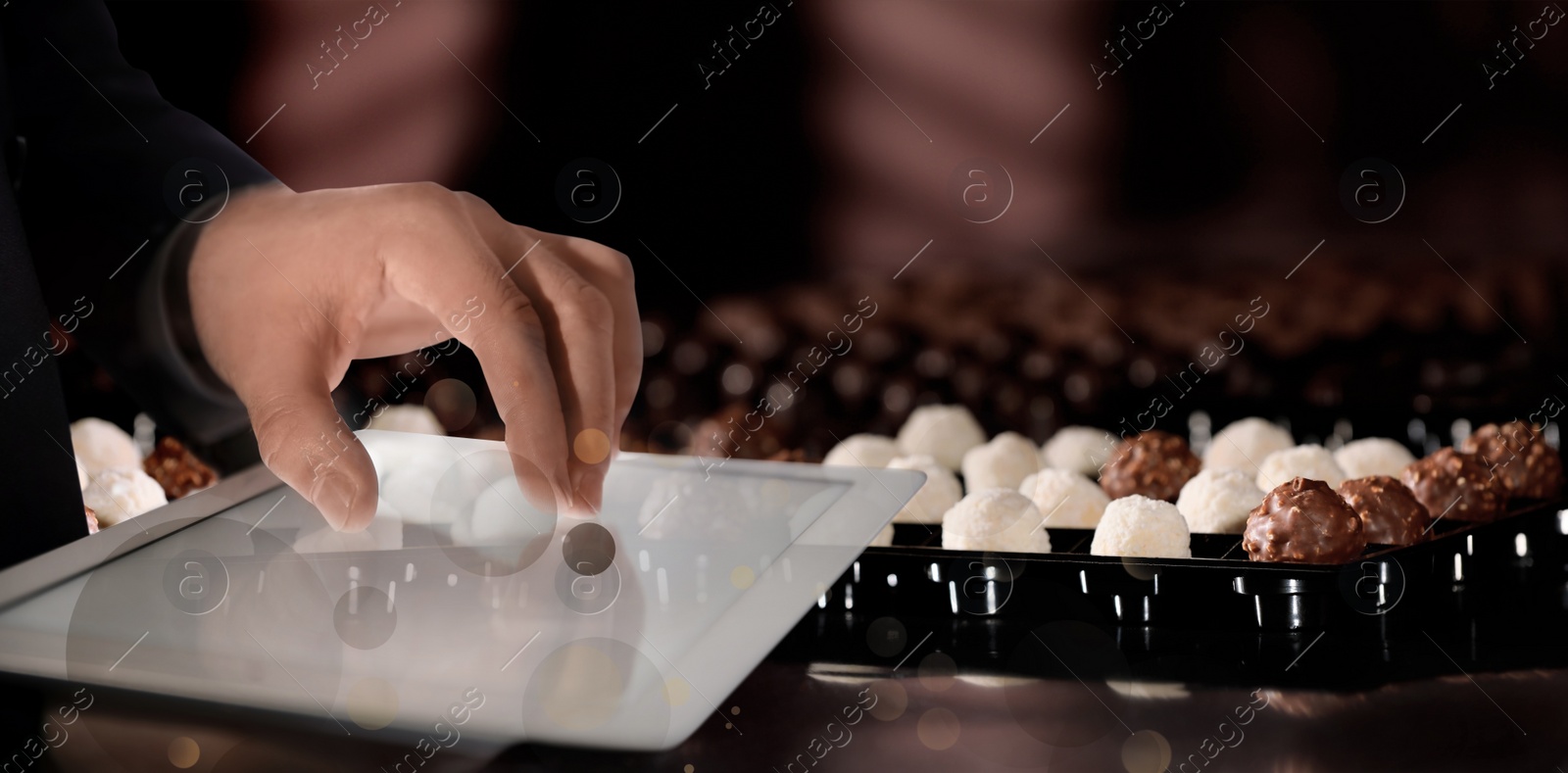 Image of Production line of chocolate candies. Man working with tablet, closeup. Banner design