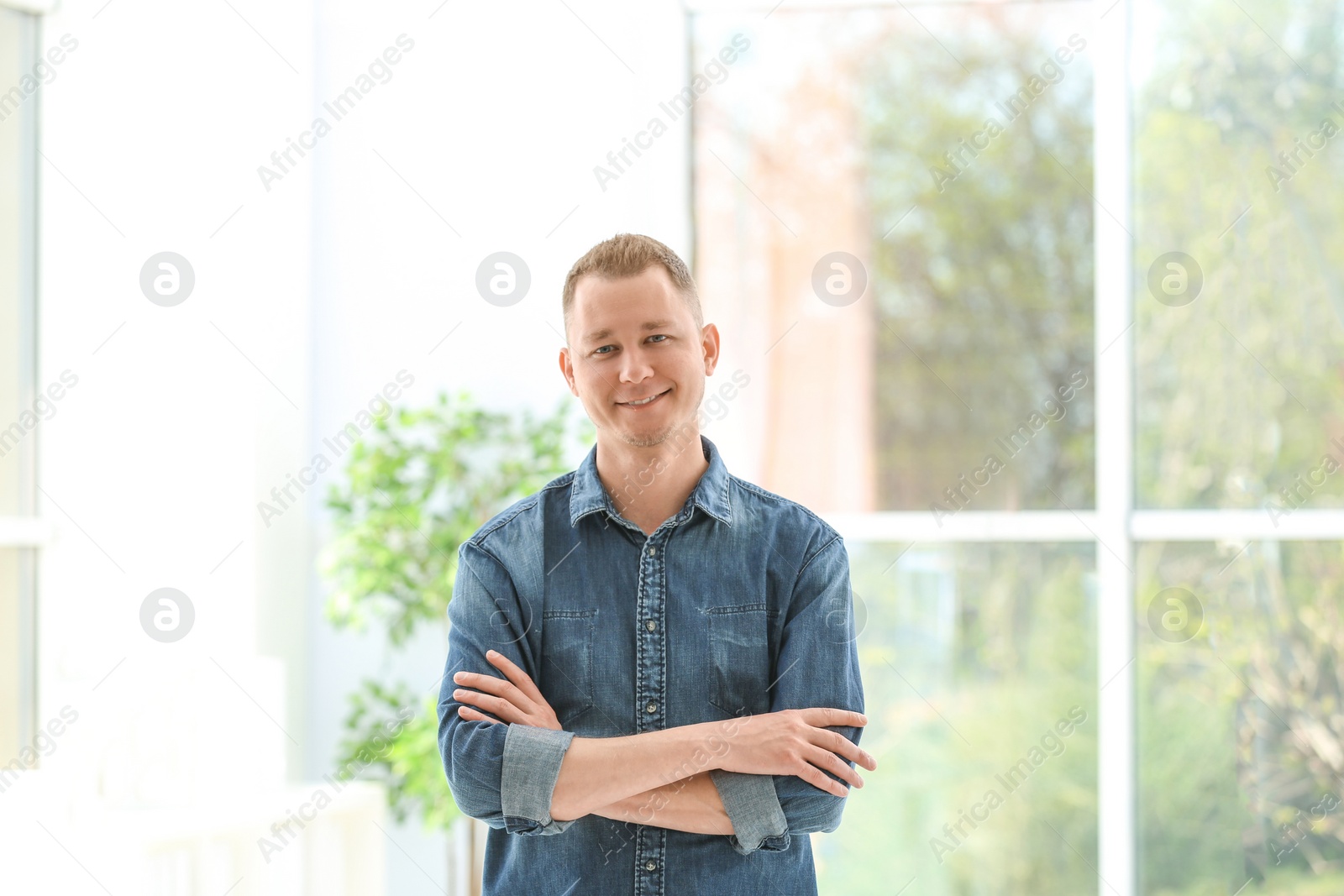 Photo of Portrait of handsome man in stylish outfit, indoors