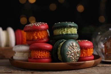 Beautifully decorated Christmas macarons and festive decor on wooden table, closeup