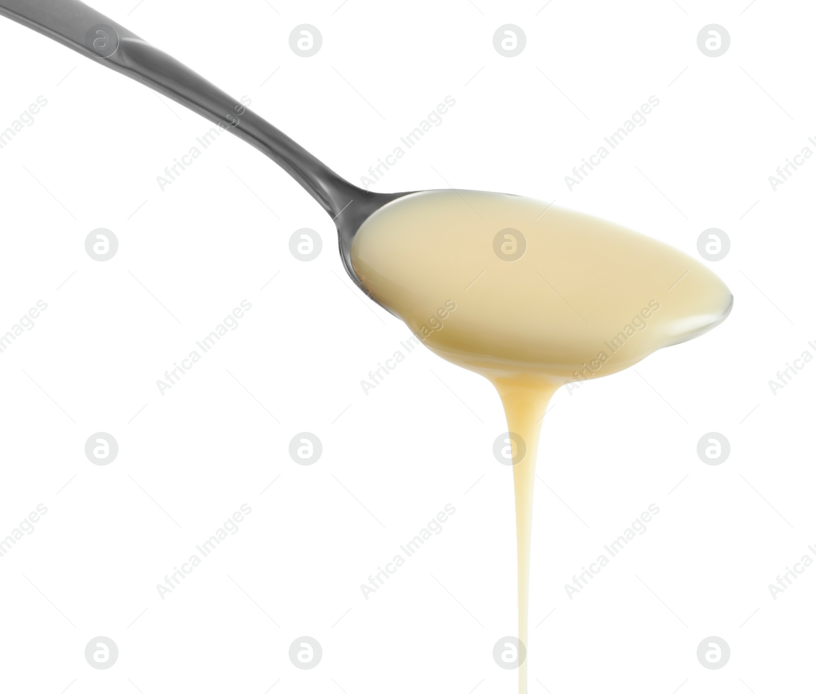 Photo of Spoon with condensed milk on white background, closeup. Dairy product