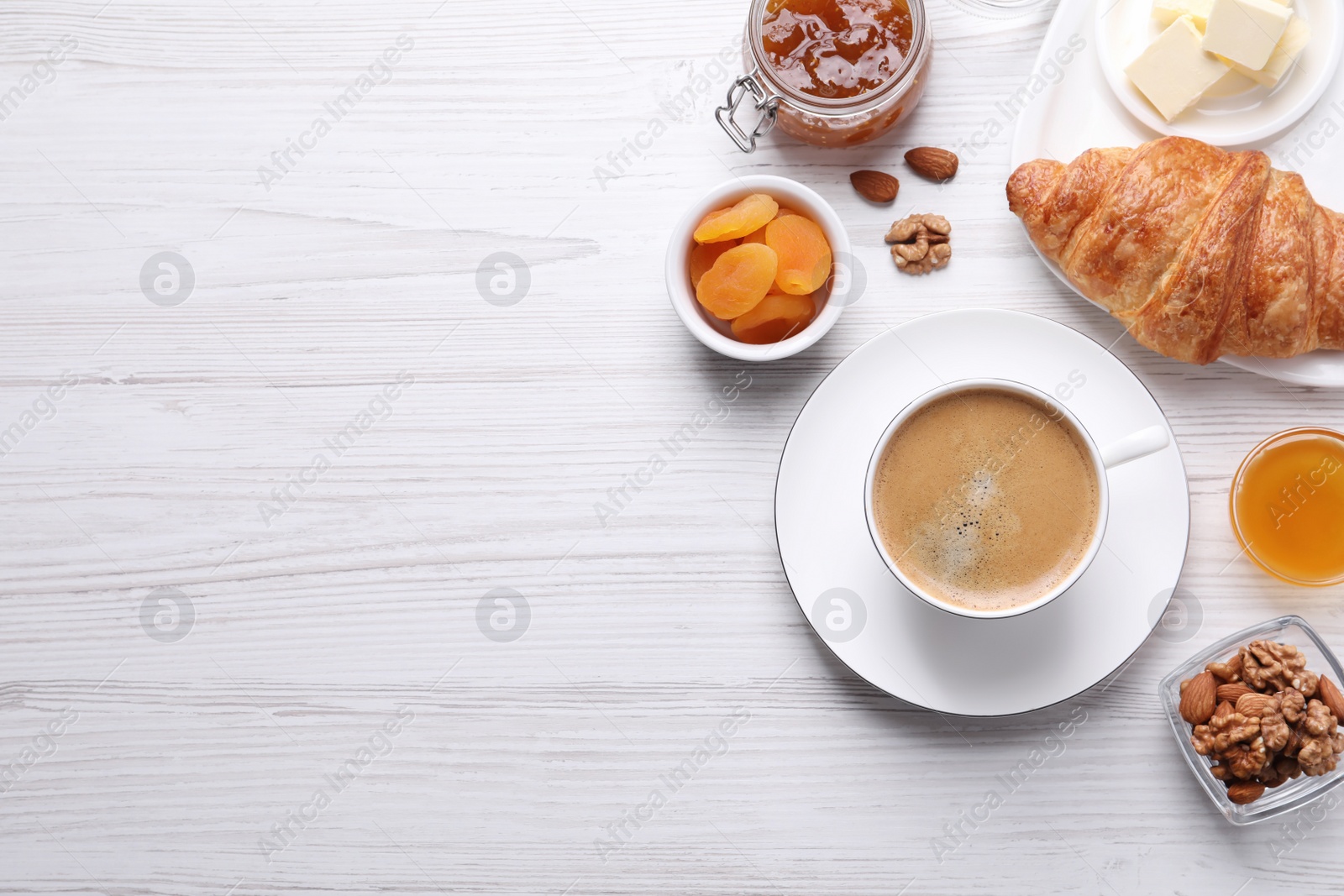 Photo of Delicious breakfast with cup of coffee on white wooden table, flat lay. Space for text
