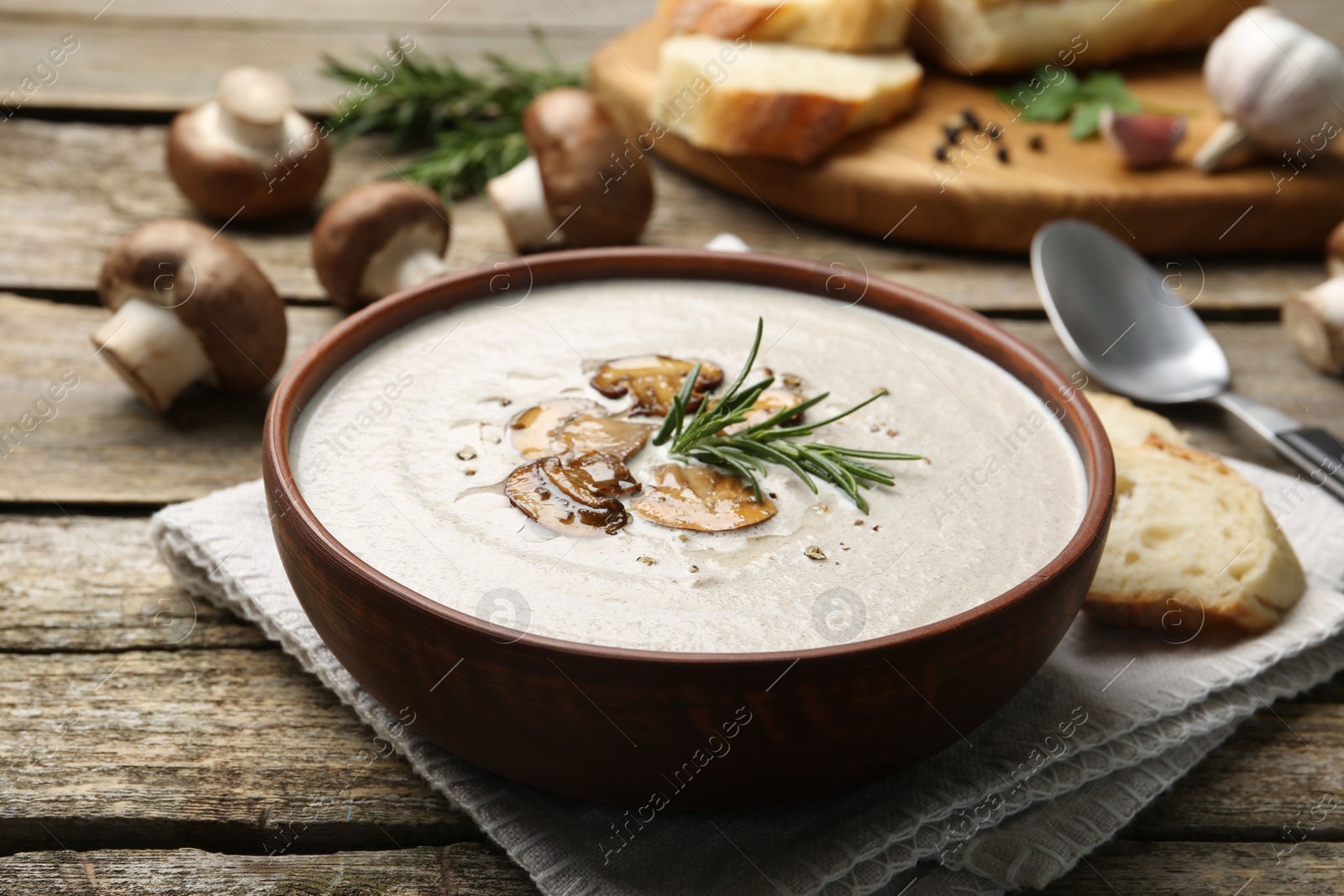 Photo of Fresh homemade mushroom soup served on wooden table