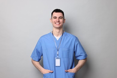 Photo of Portrait of smiling medical assistant on grey background