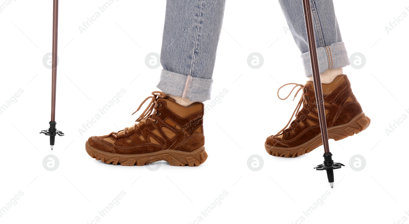 Photo of Woman wearing stylish hiking boots with trekking poles on white background, closeup