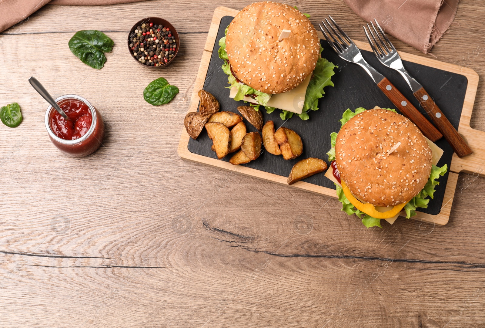 Photo of Flat lay composition with tasty hamburgers on wooden background. Space for text