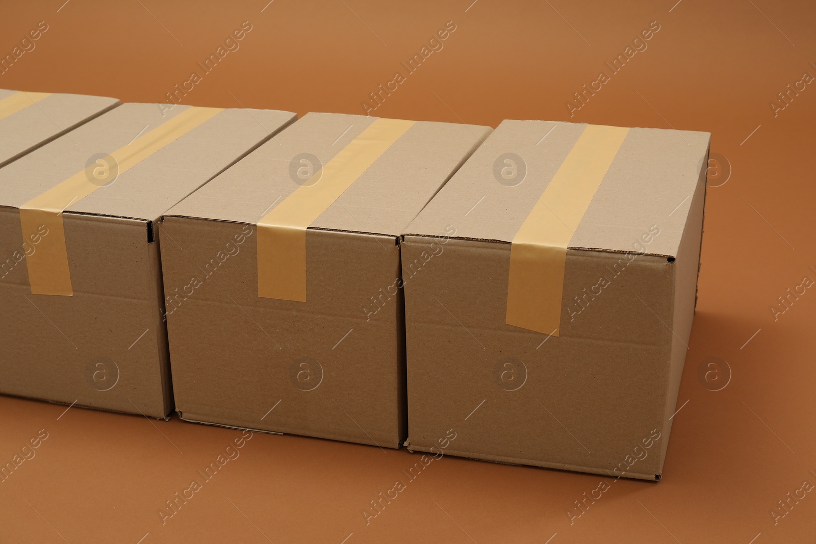 Photo of Group of cardboard boxes on brown background