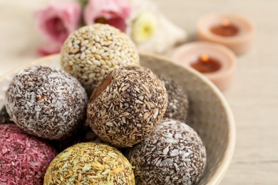 Different delicious vegan candy balls in bowl, closeup