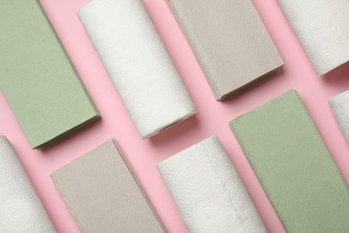 Photo of Paper towels and napkins on pink background, flat lay