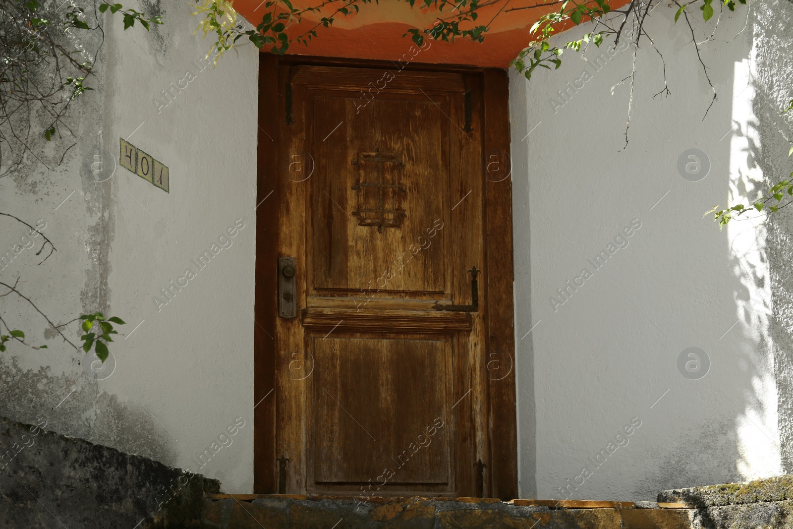 Photo of House entrance with old wooden door outdoors