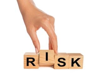 Photo of Woman making word Risk of wooden cubes on white background, closeup