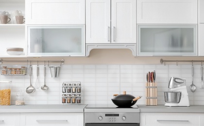 Photo of Modern kitchen interior with houseware and new furniture