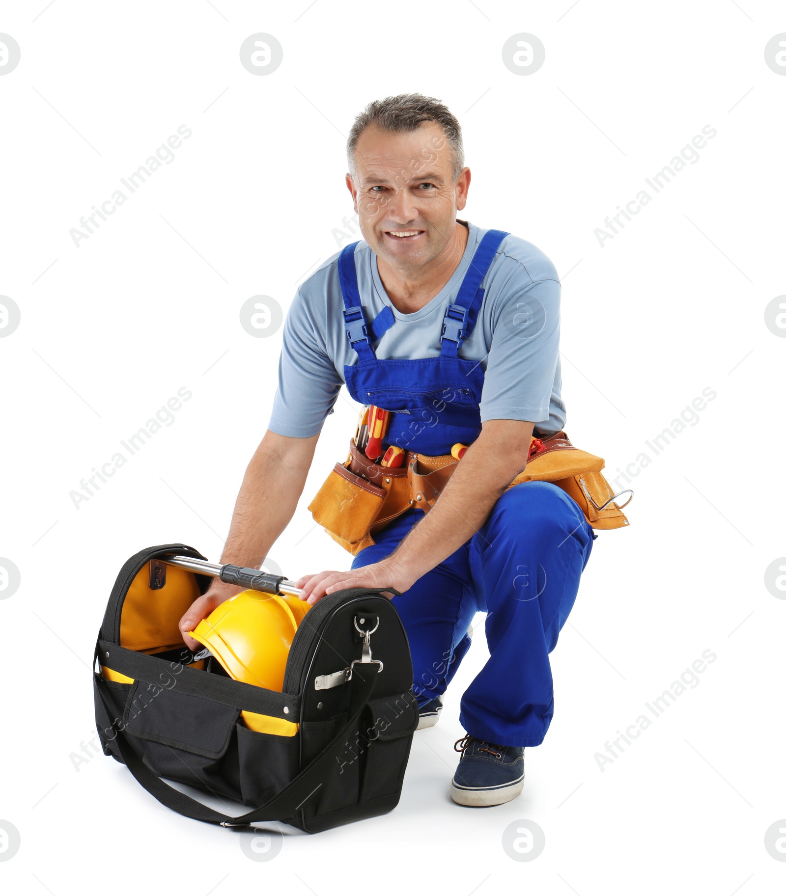 Photo of Electrician with tools wearing uniform on white background