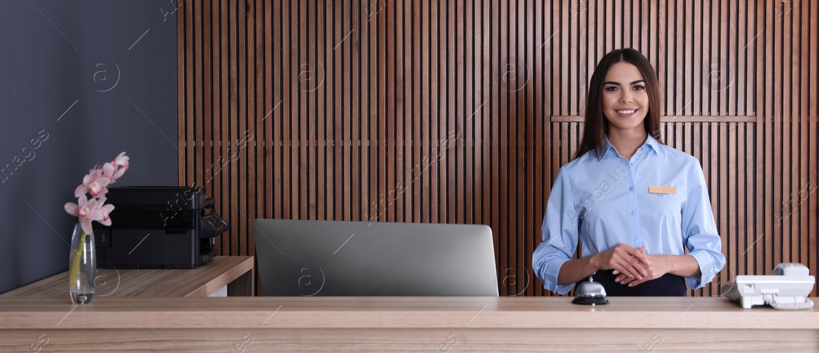 Image of Portrait of receptionist at desk in lobby. Banner design