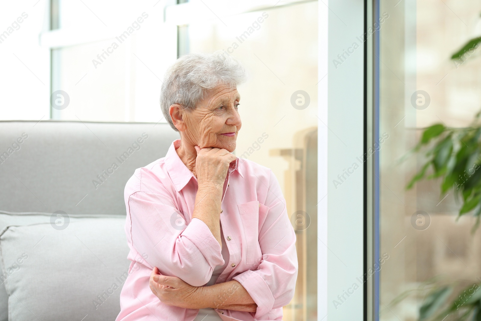 Photo of Portrait of beautiful grandmother in living room