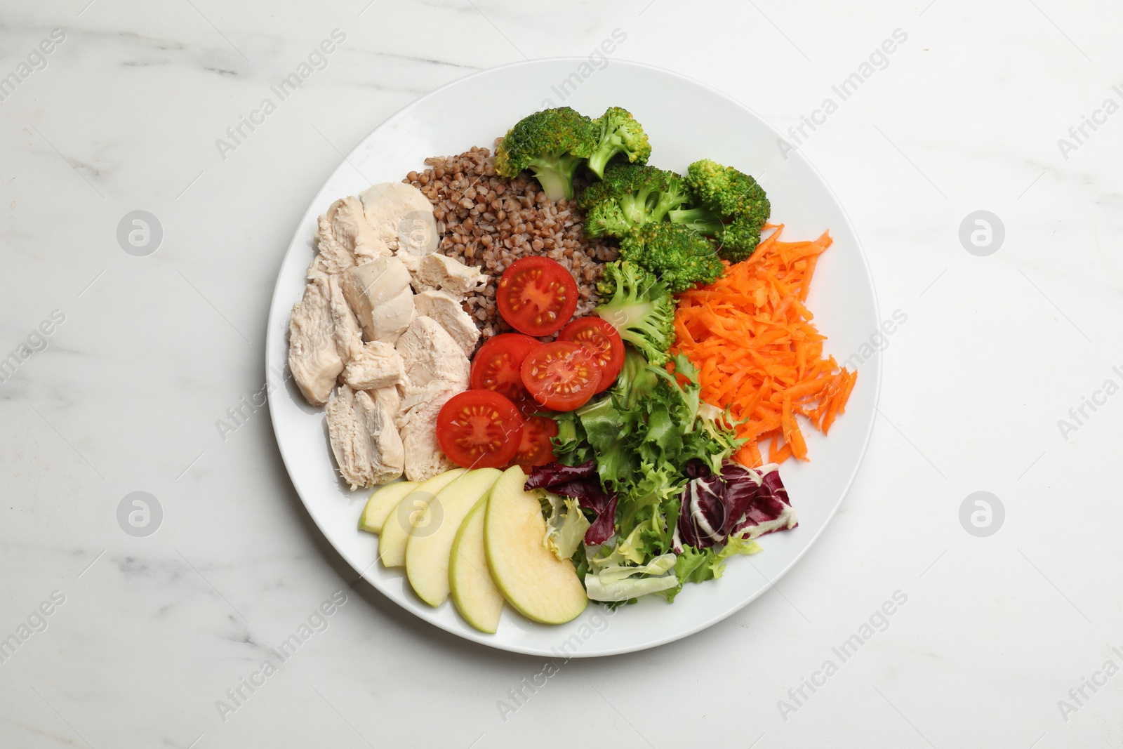 Photo of Balanced diet and healthy foods. Plate with different delicious products on white marble table, top view