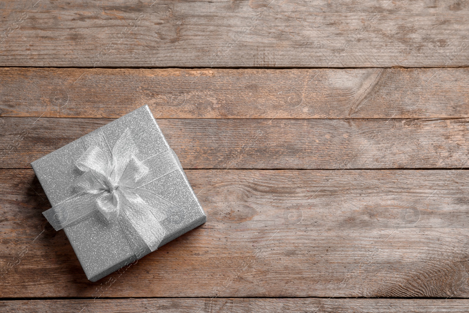 Photo of Beautiful gift box on wooden background, top view