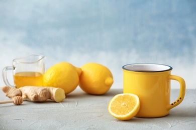 Photo of Cup of hot tea and lemon on table. Space for text