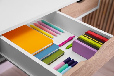 Photo of Office supplies in open desk drawer indoors, closeup