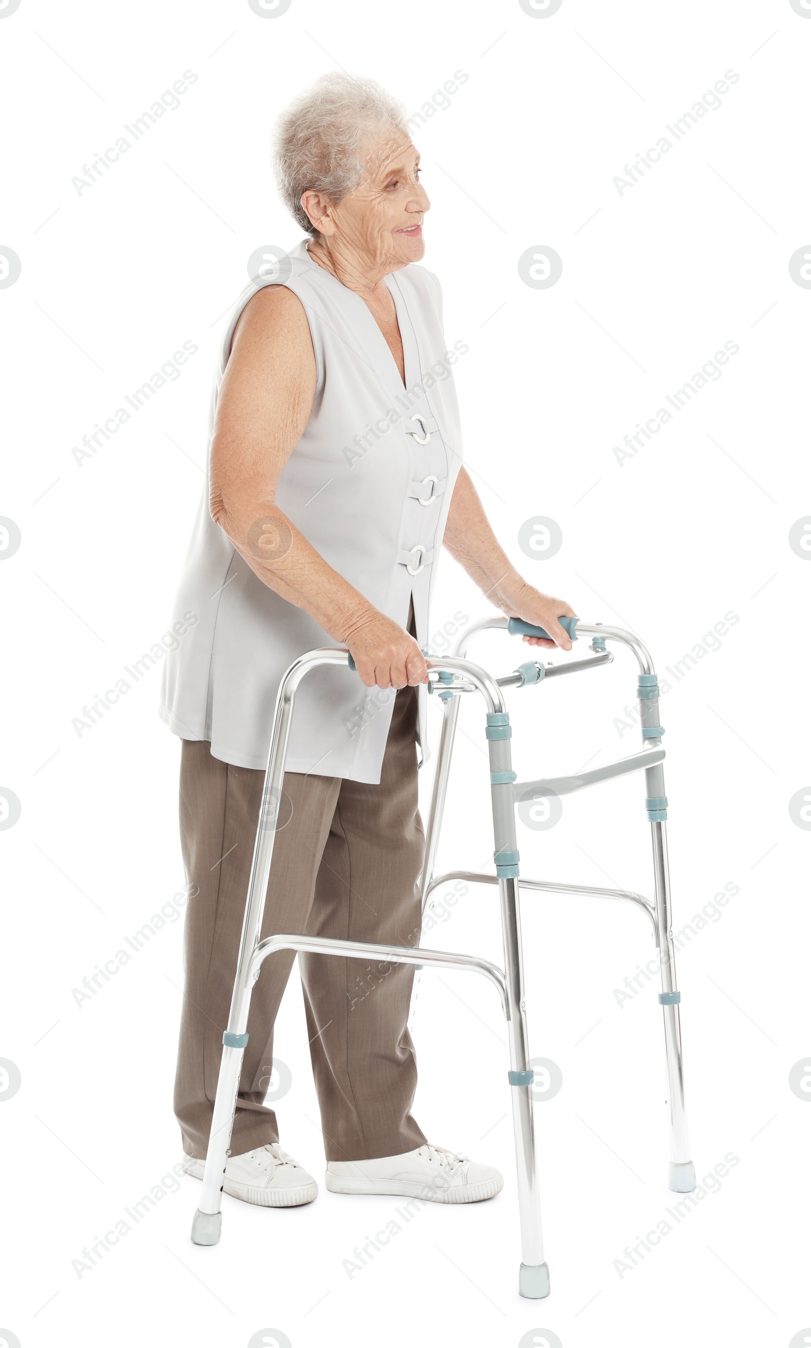 Photo of Full length portrait of elderly woman using walking frame isolated on white