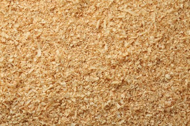 Photo of Dry natural sawdust as background, top view