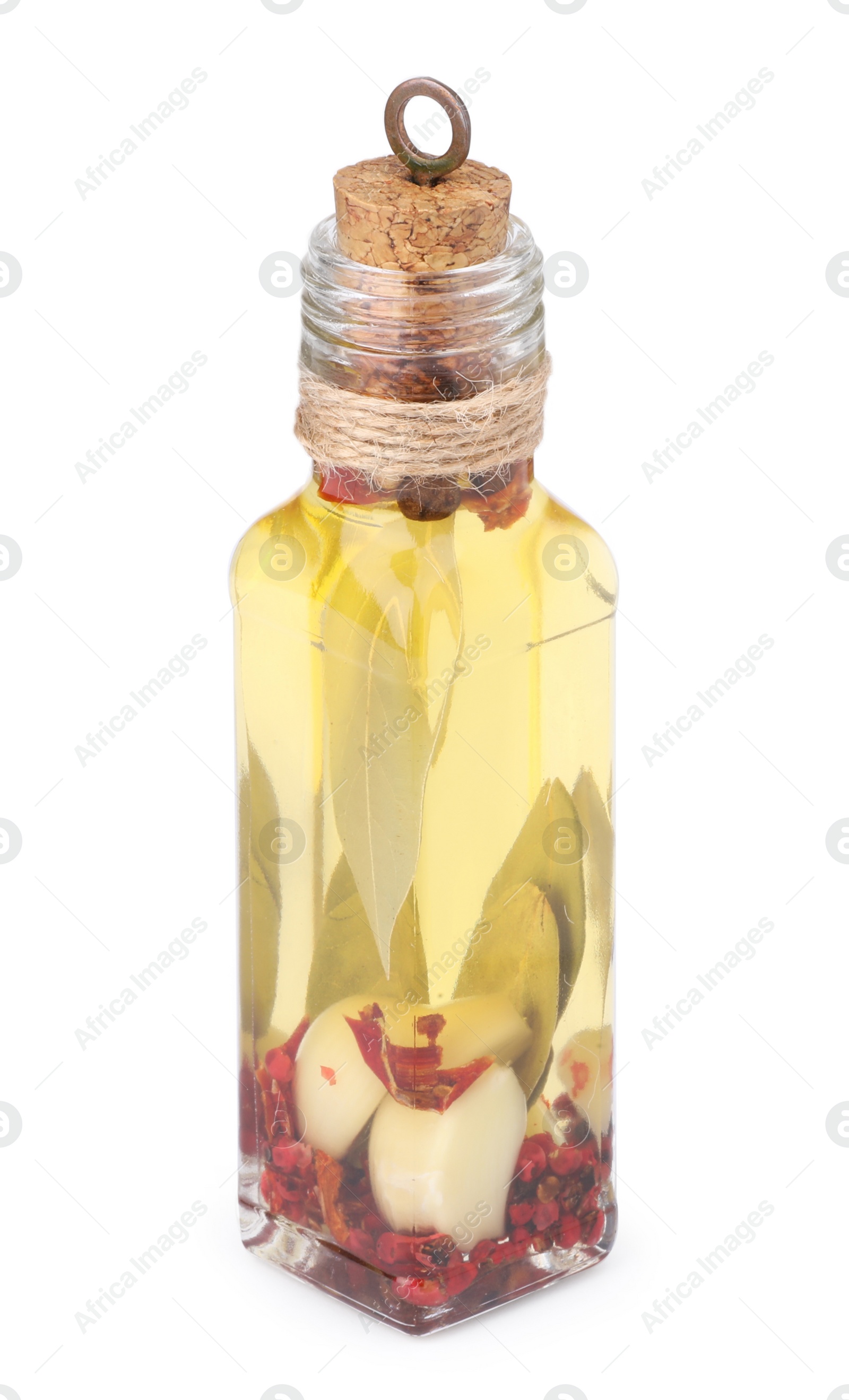 Photo of Glass bottle of cooking oil with spices and herbs isolated on white