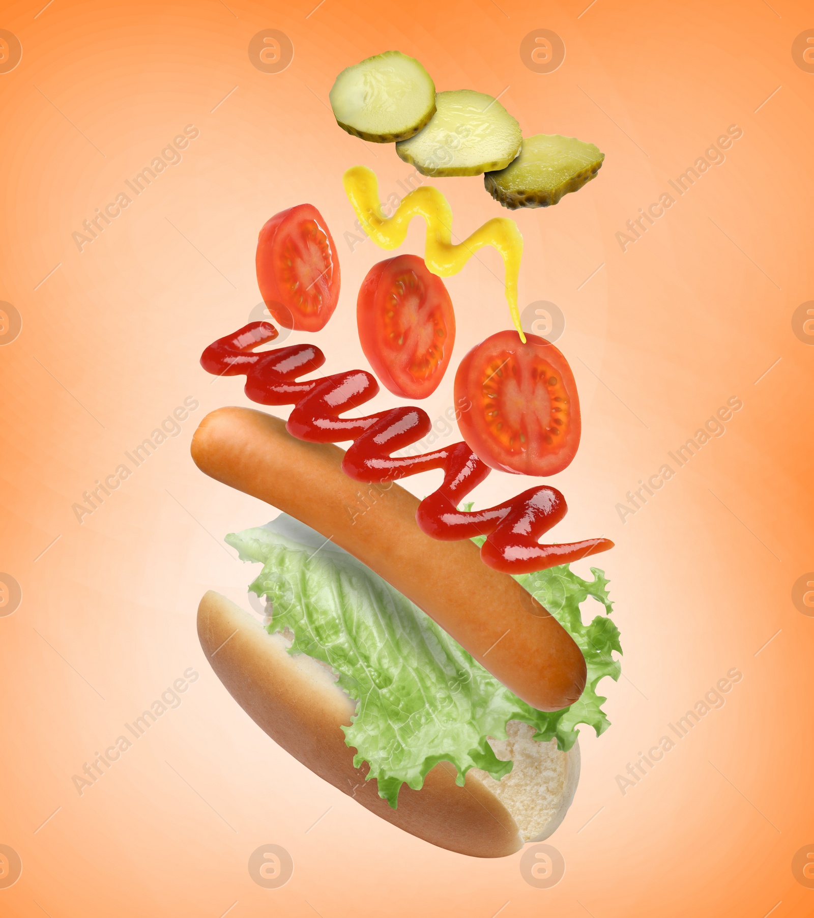 Image of Hot dog ingredients in air on orange gradient background