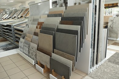 Photo of Assortment of tiles in store. Many different samples indoors