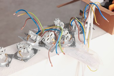 Many power sockets with wires indoors, closeup