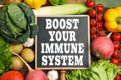 Image of Boost your immune system with proper diet. Different foods and small chalkboard, flat lay