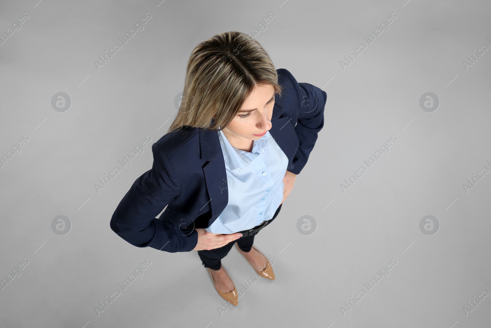 Photo of Young woman on grey background, above view