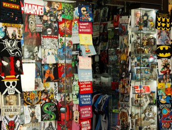Photo of San Marino, San Marino - August 17, 2022: Different T-shirts, patches, stickers, comics, posters and figures of heroes in shop window