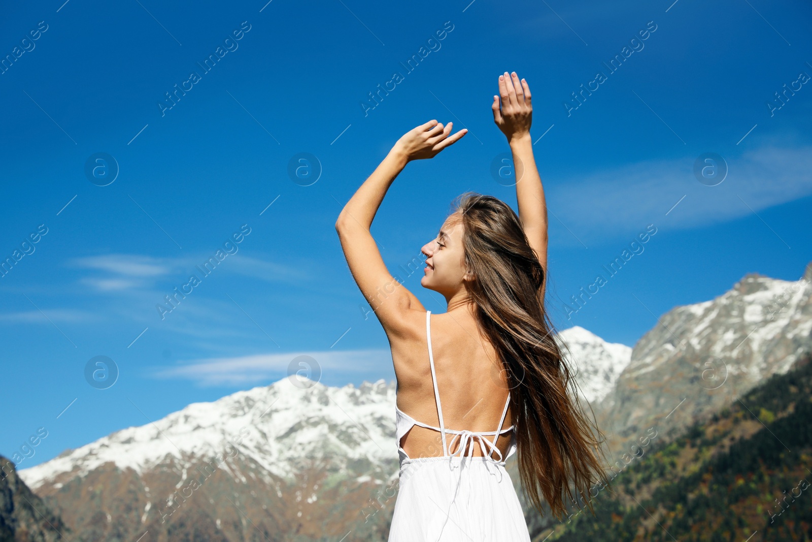 Photo of Young woman walking in beautiful mountains on sunny day