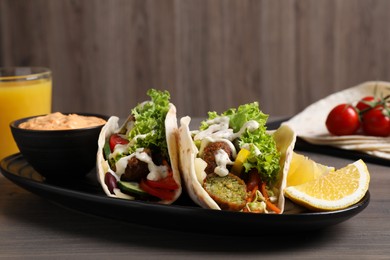 Delicious fresh vegan tacos served on wooden table