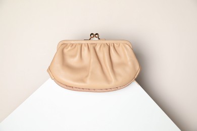 Stylish presentation of leather purse on light background, top view