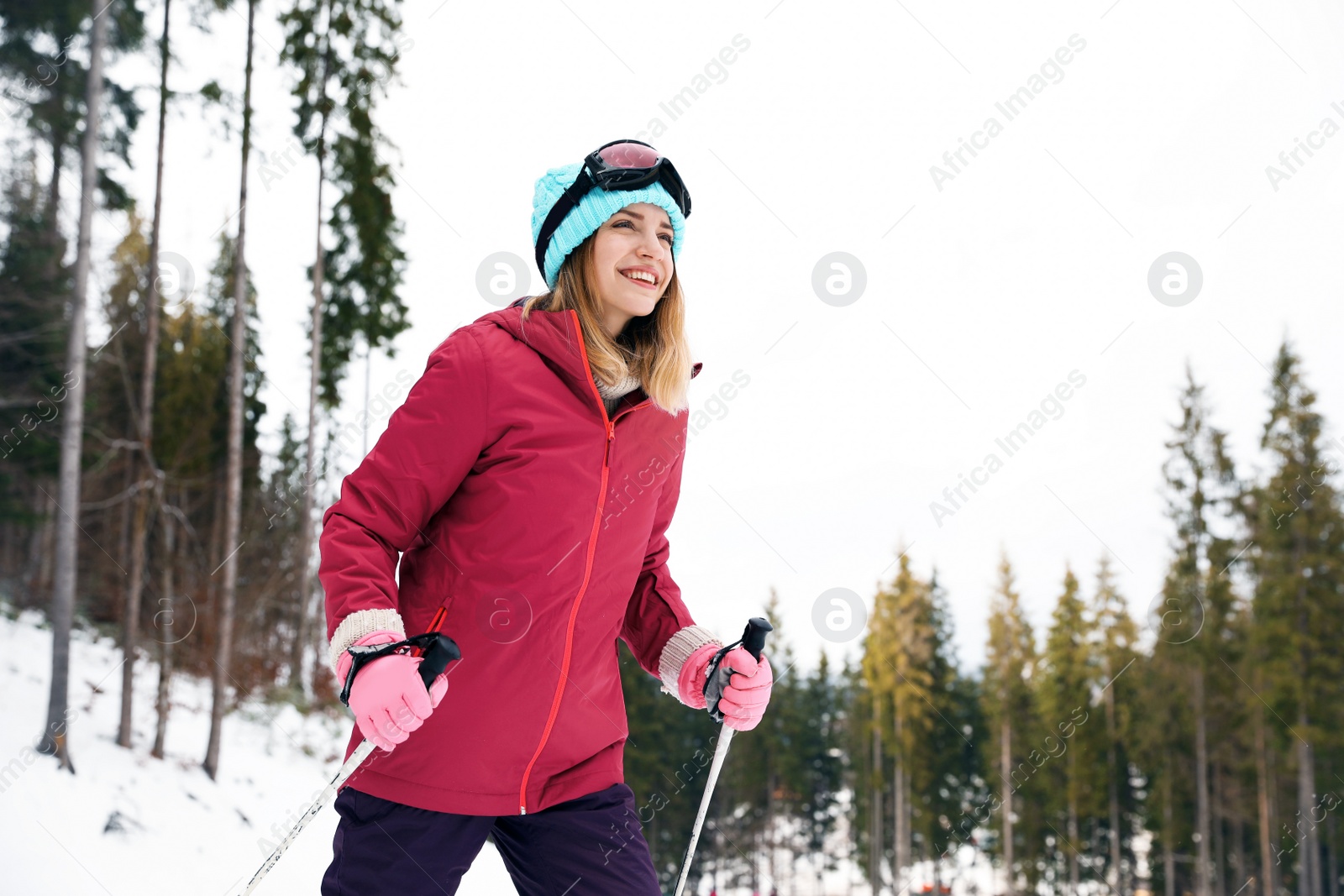 Photo of Female skier on slope at resort. Winter vacation