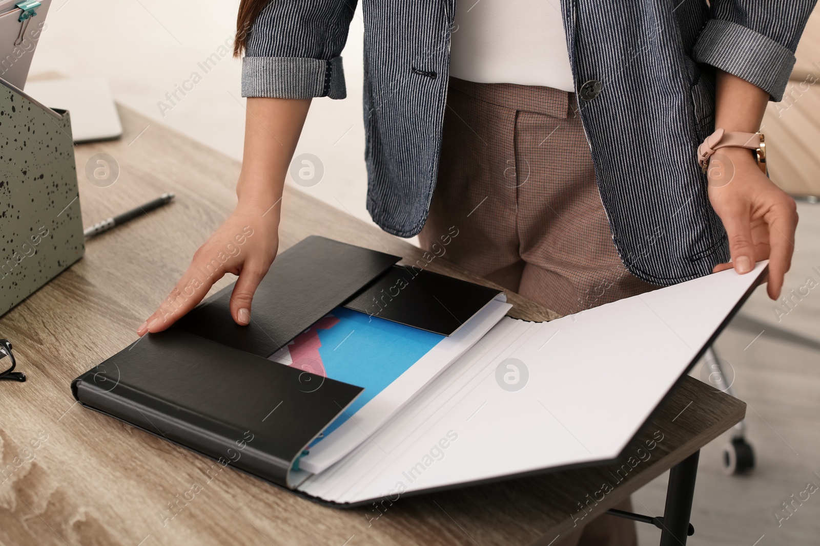 Photo of Businesswoman working with documents at office table, closeup