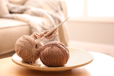 Photo of Yarn and knitting needle on table at home. Creative hobby