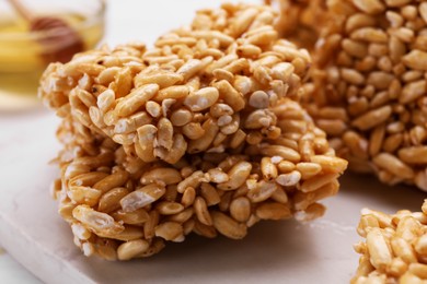 Puffed rice bars (kozinaki) on white table, closeup