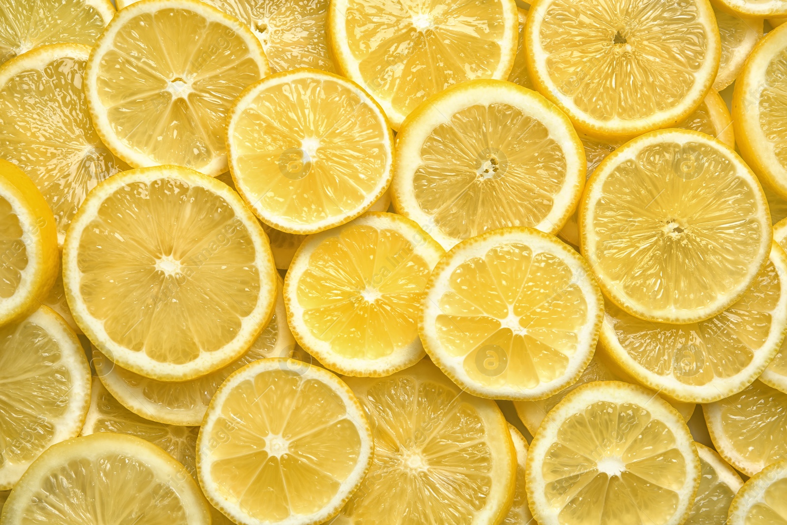 Photo of Slices of fresh juicy lemons as background