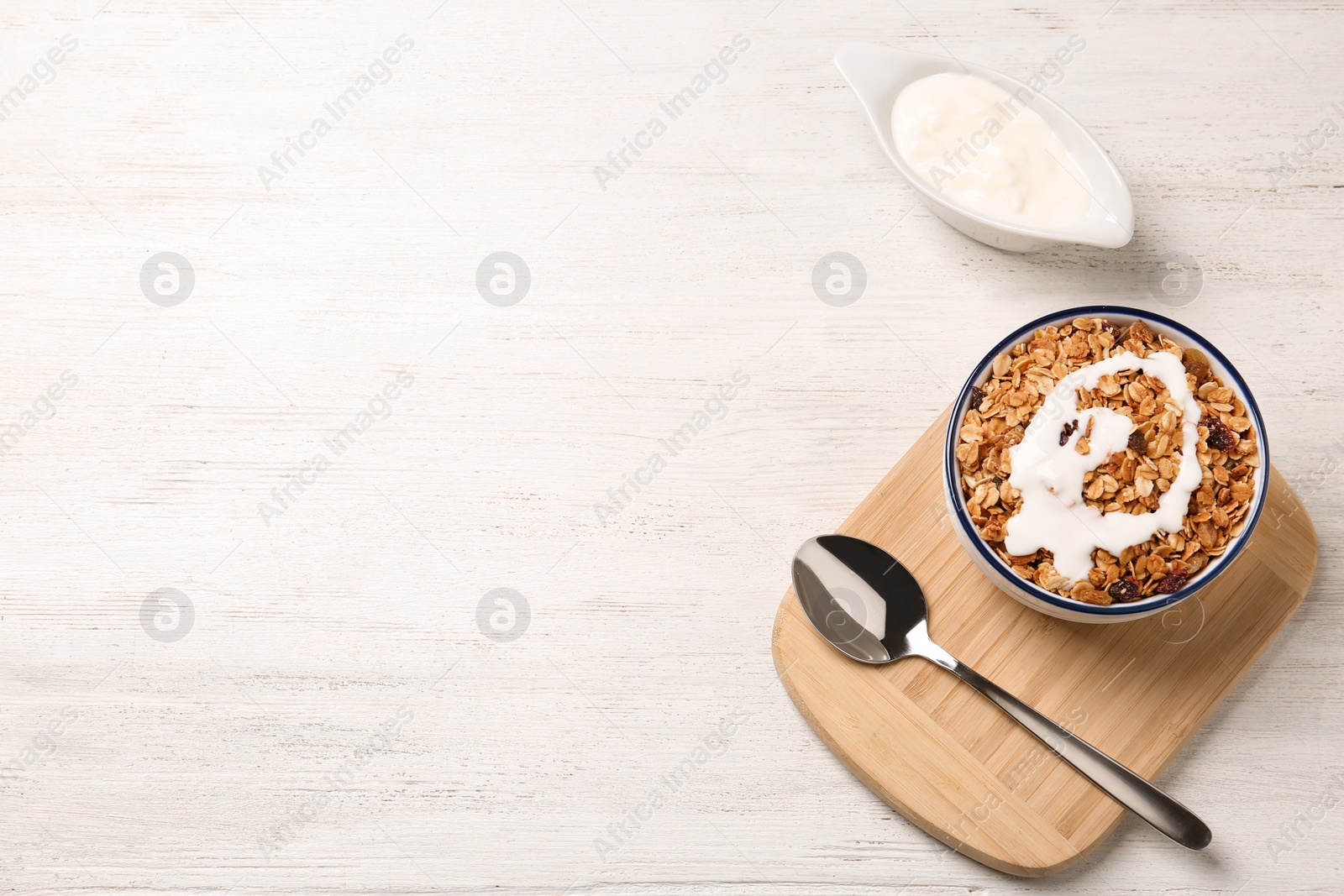 Photo of Flat lay composition with muesli on white wooden table, space for text. Delicious breakfast