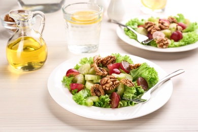 Photo of Delicious fresh celery salad on white wooden table