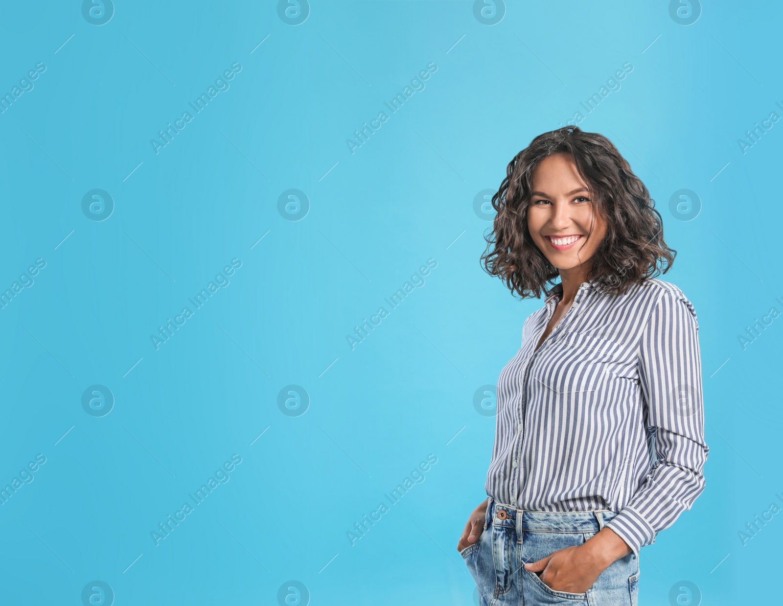 Photo of Happy young woman in casual outfit on blue background. Space for text