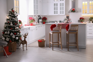 Beautiful kitchen interior with Christmas tree and festive decor