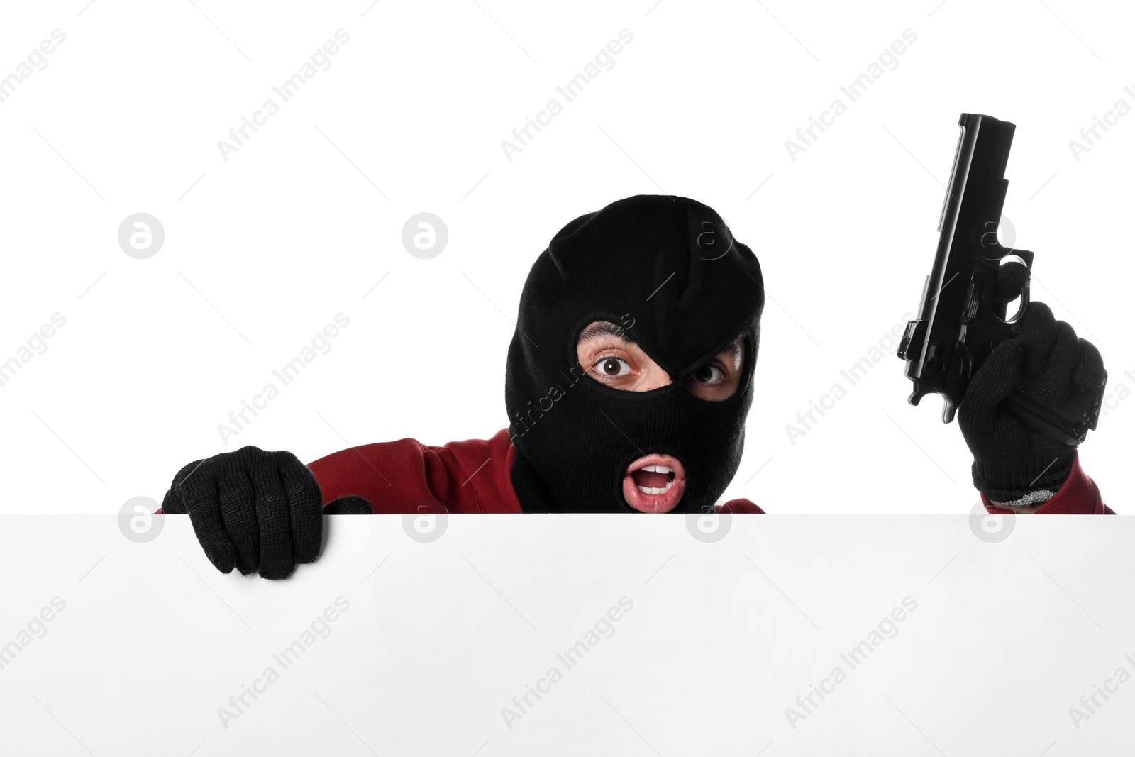 Photo of Emotional thief in balaclava with gun on white background