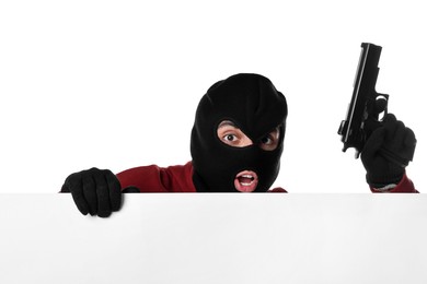 Emotional thief in balaclava with gun on white background